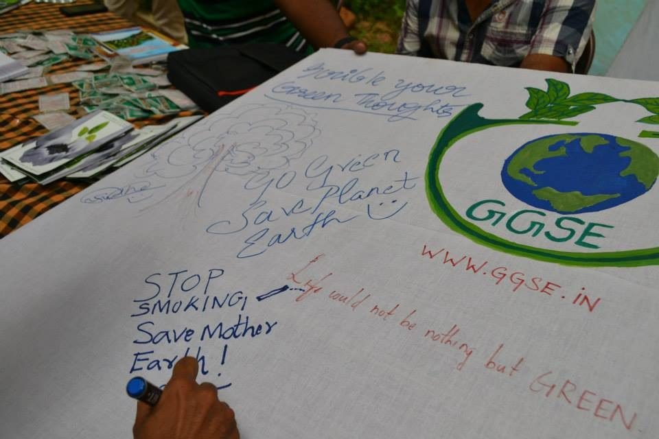 Volunteers signing a Go Green pledge banner